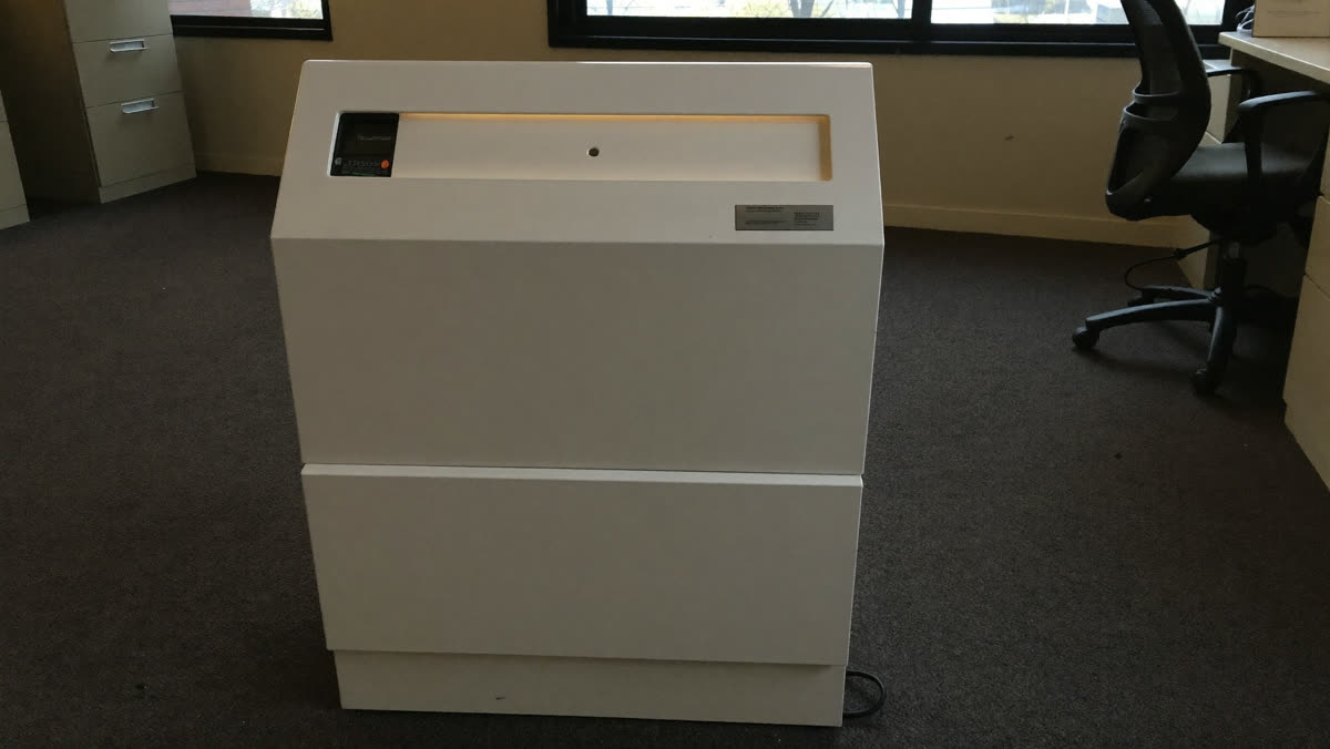 Ozone generator running in an empty office room during odor treatment